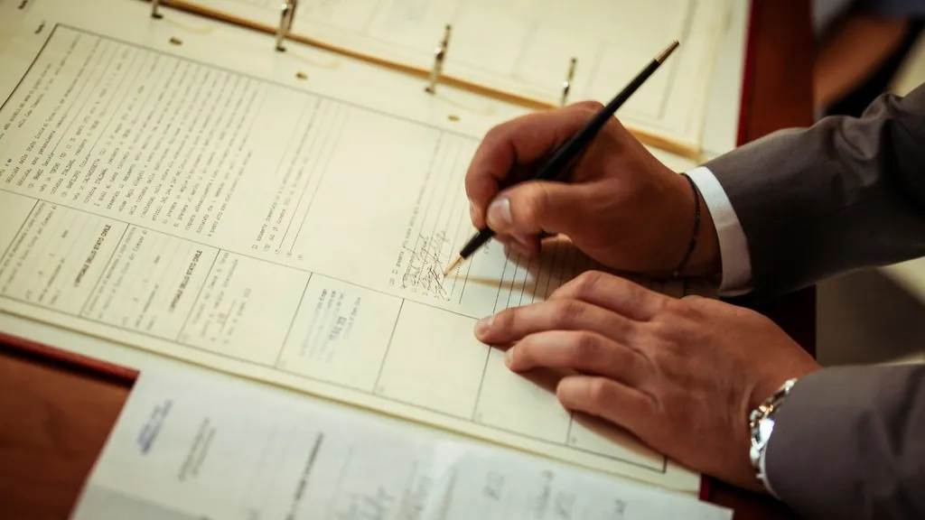 Hands signing a home sale contract at the start of the attorney review period in NJ