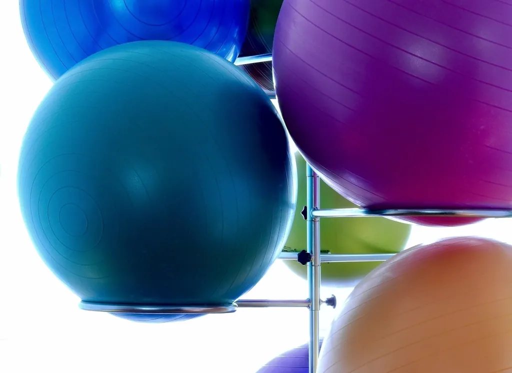 Colorful exercise balls stored on a metal rack