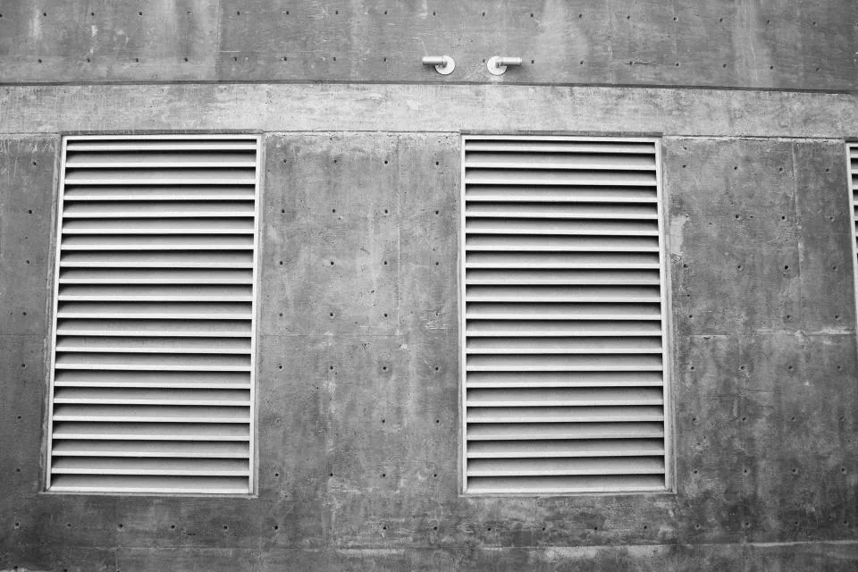 Louvered air vents set into a concrete wall