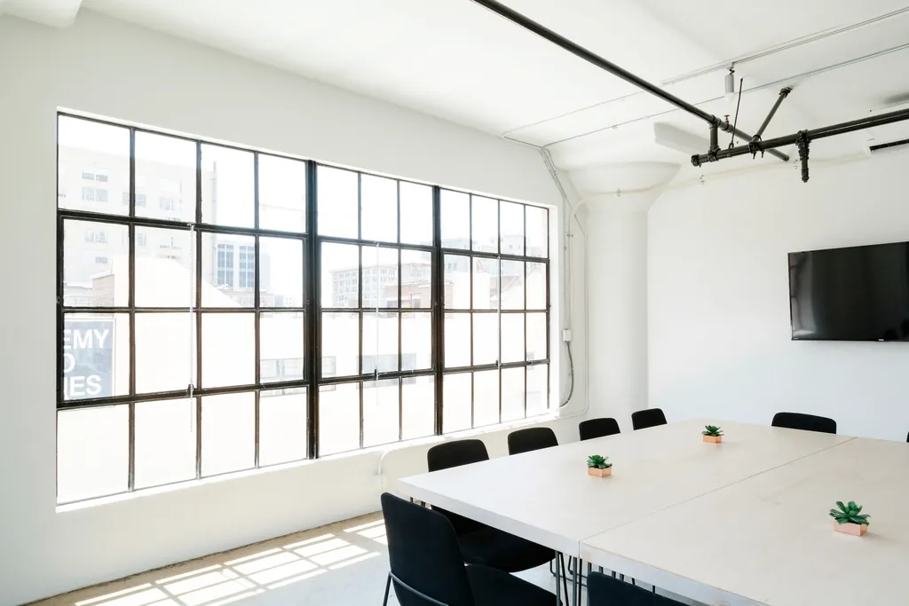 Bright conference room with tall factory-style windows