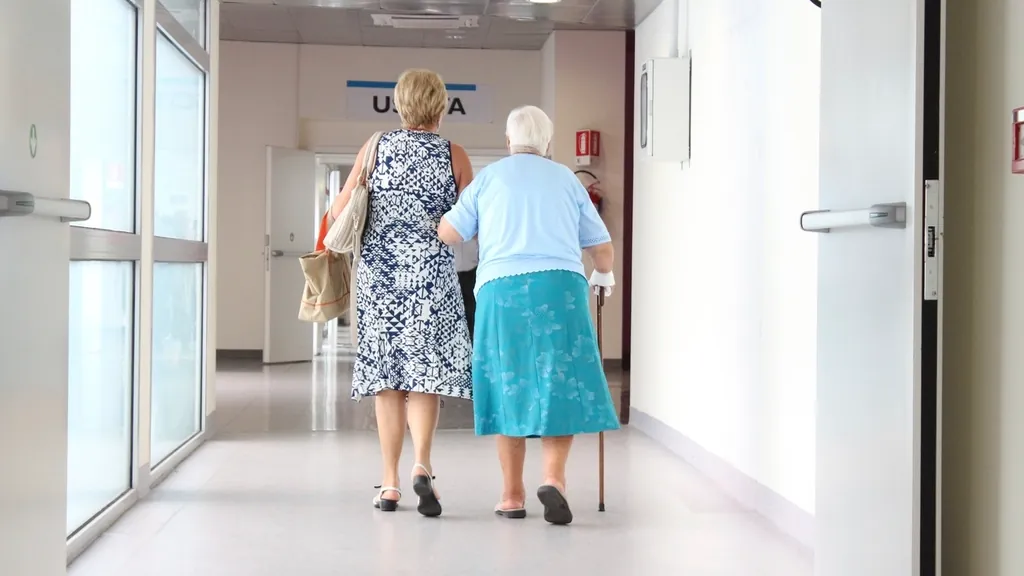 Adult daughter walking beside her mother with a cane, a time many families talk to an elder law attorney in NJ