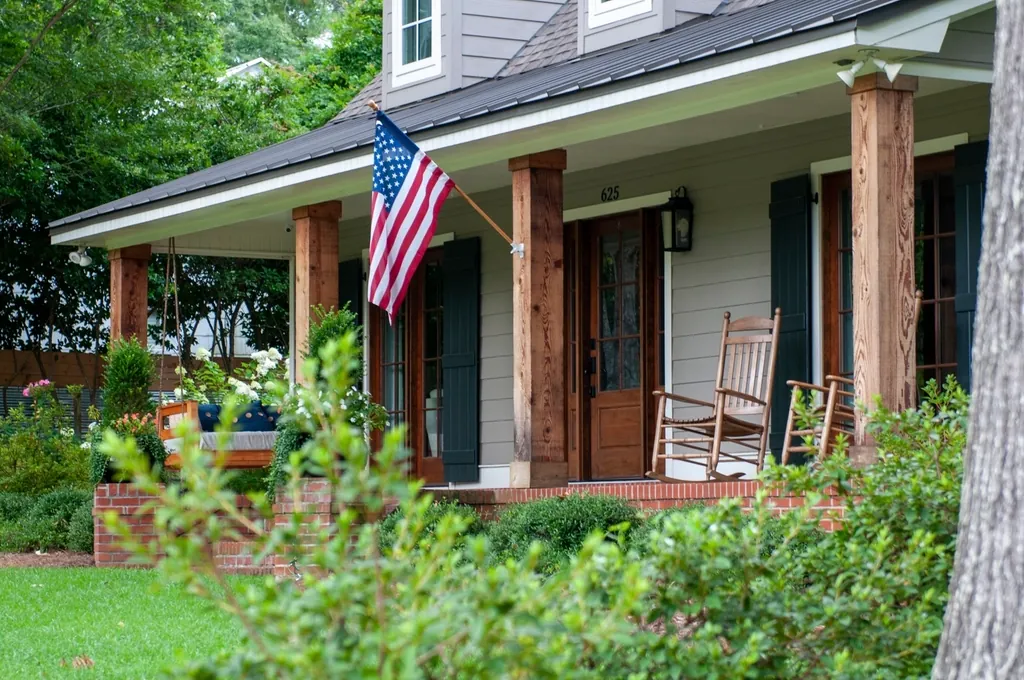 Front porch with rocking chairs and an American flag