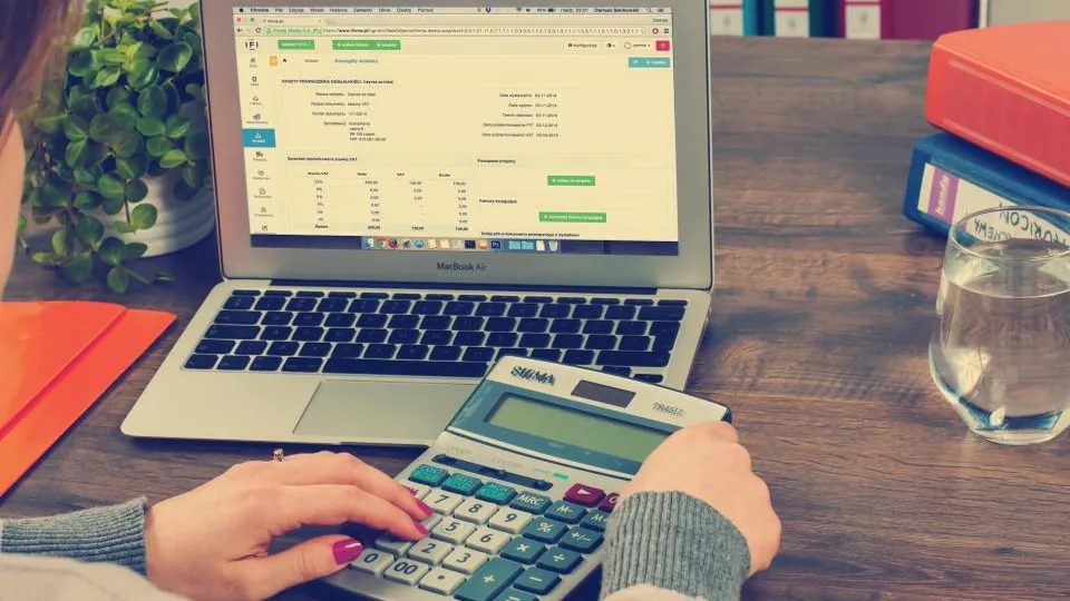 Person adding up household numbers before a first meeting with a financial advisor