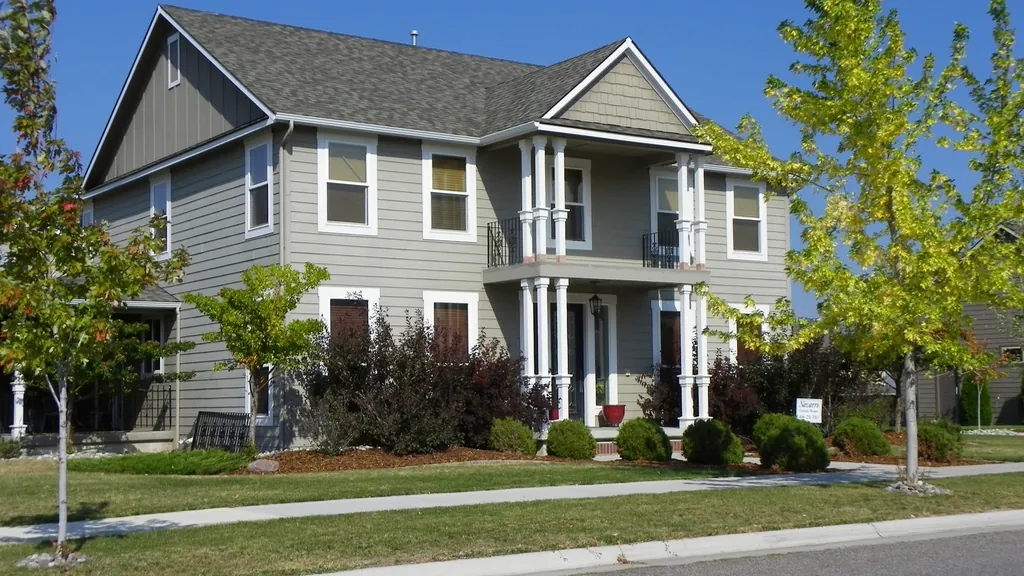 Gray two-story colonial on a tree-lined street, the type of house valued in a home appraisal in NJ