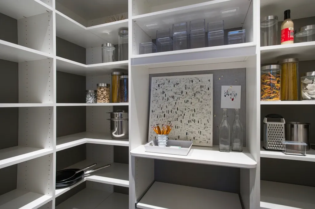 Pantry shelves with dry food stored in sealed glass and plastic containers