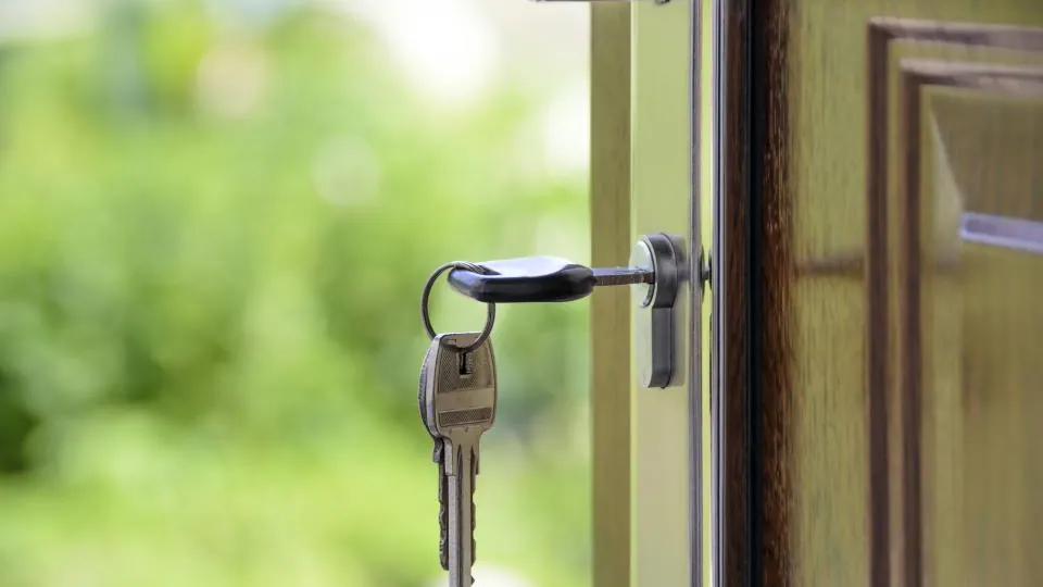 Key in the front door of a house, a reminder about life insurance for new homeowners Key in the front door of a house, a reminder about life insurance for new homeowners