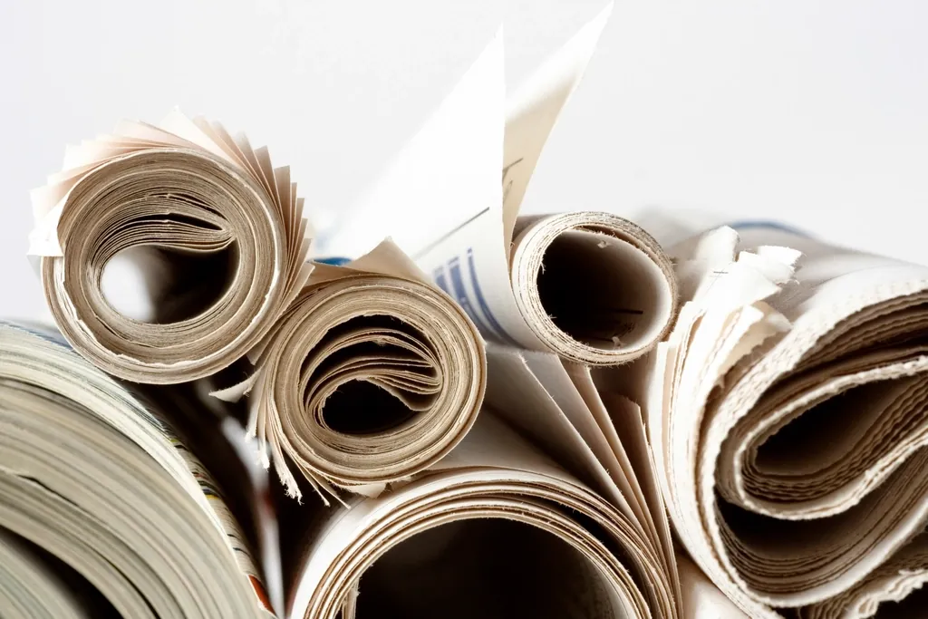 Stack of rolled and folded newspapers