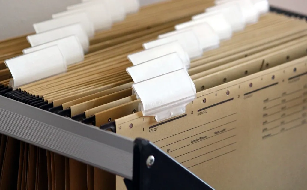 Hanging file folders with blank labels in a drawer