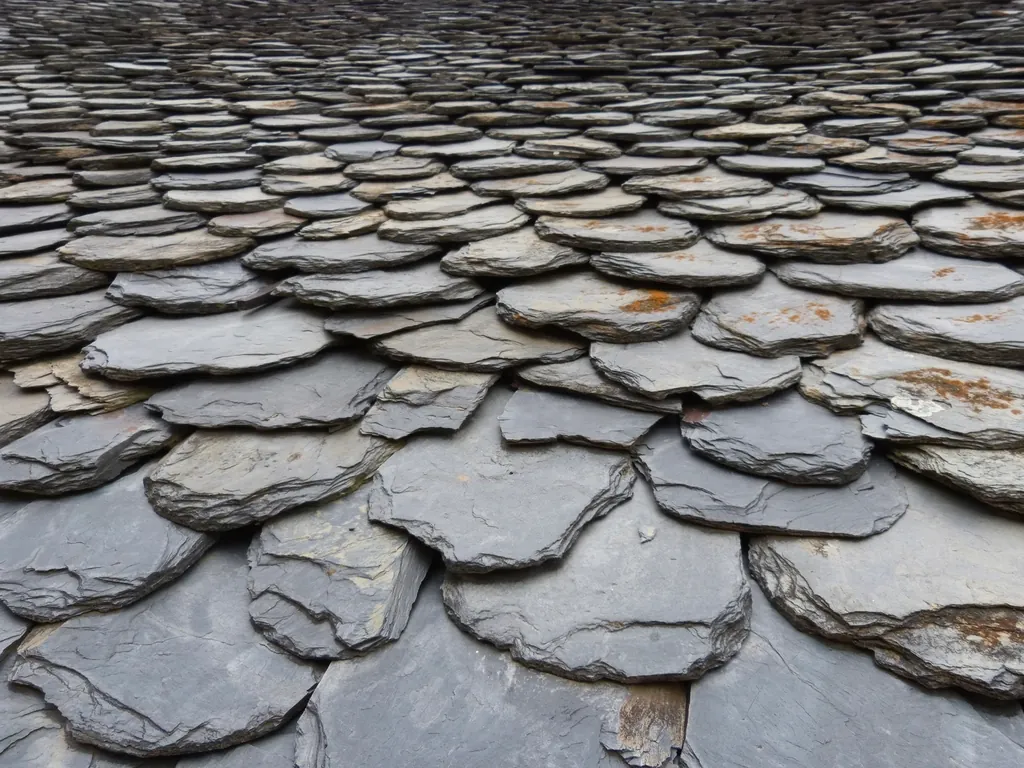 Close-up of overlapping gray slate roof tiles