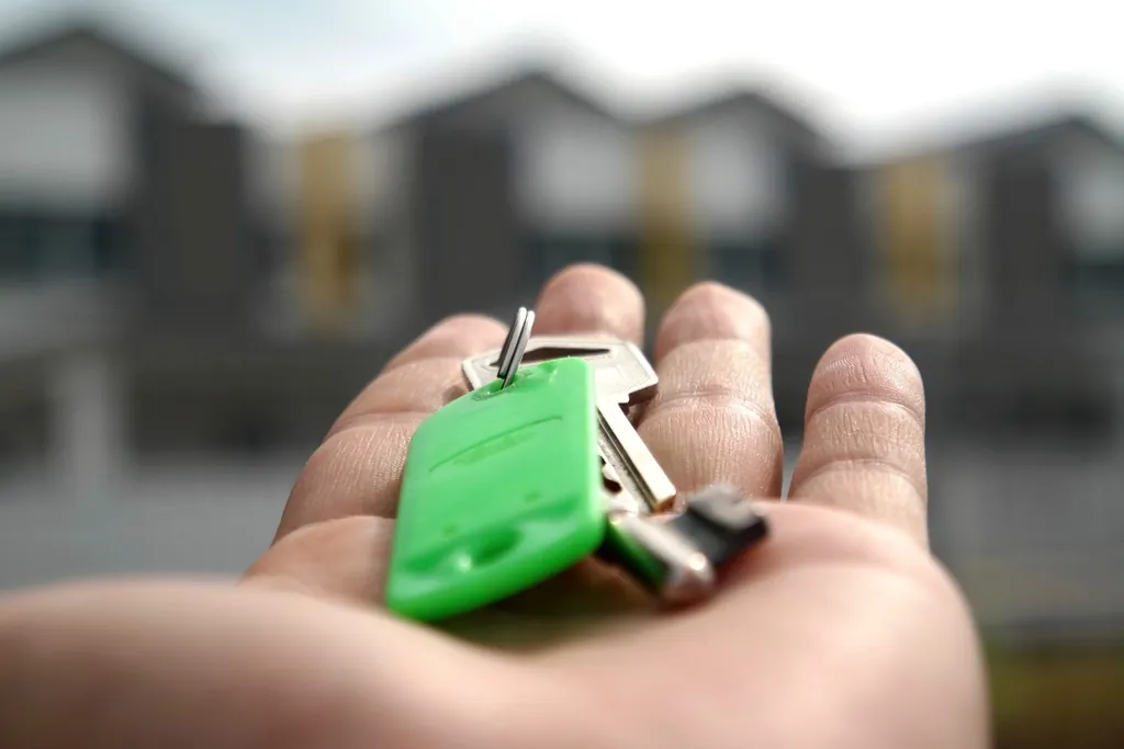 New homeowner holding the house keys after closing